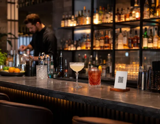A guest opening a bar menu from a QR code on a phone