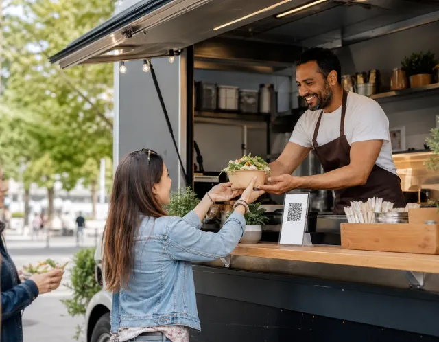 A guest opening a food truck menu from a QR code on a phone