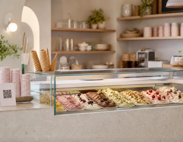 A guest opening a ice cream shop menu from a QR code on a phone