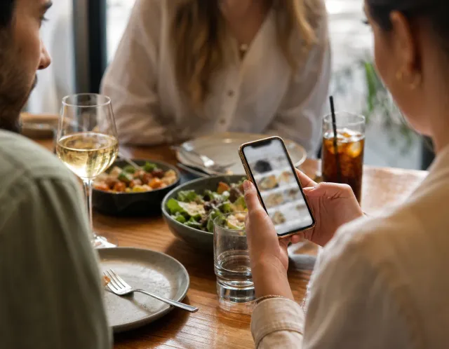 A guest opening a restaurant menu from a QR code on a phone